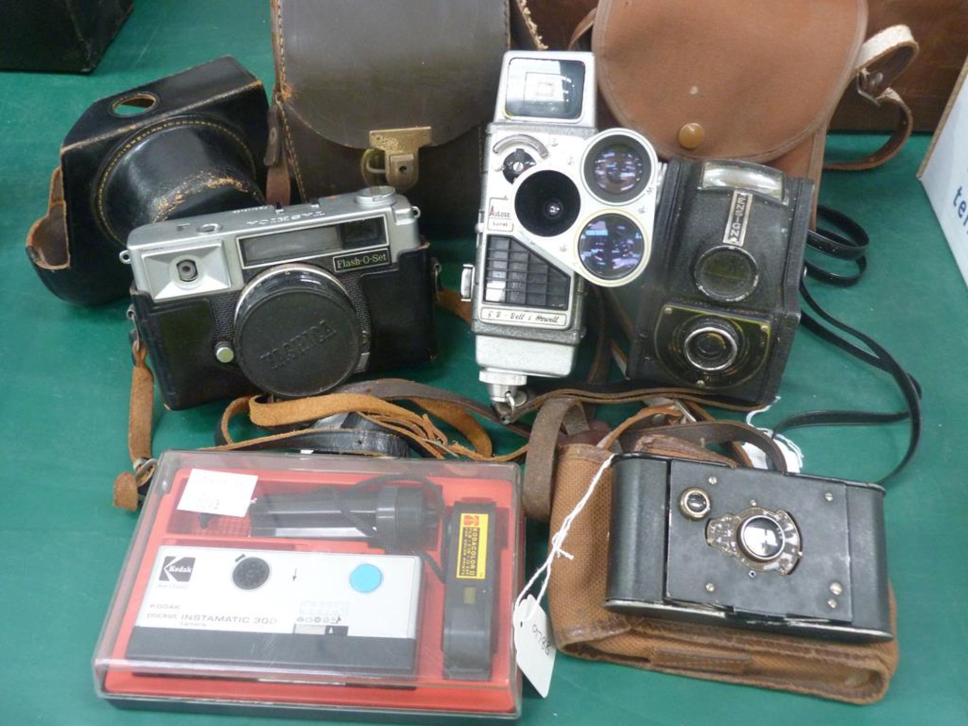 A total of four early cameras together with an early G.B Bell + Howell Hand Operated Cine Camera (