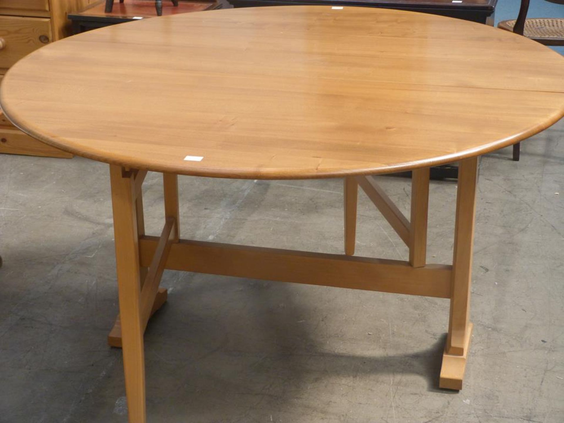 An Ercol (space saver) narrow oval drop leaf Dining Table (140cm extended) (est £50-£80)