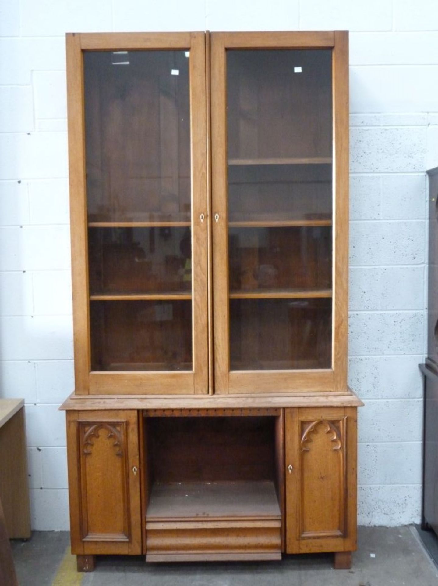 A Bookcase Cabinet with two columns of adjustable shelves behind locking (with key) glass doors