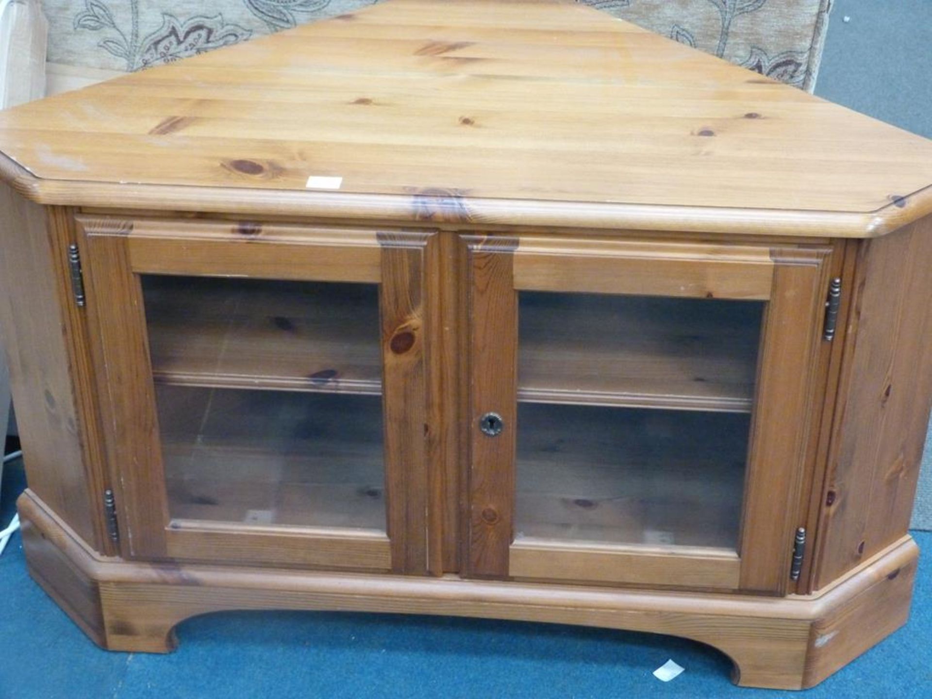 * A 'Ducal' modern Pine Corner TV Stand with Glazed Doors (est £20-£40)