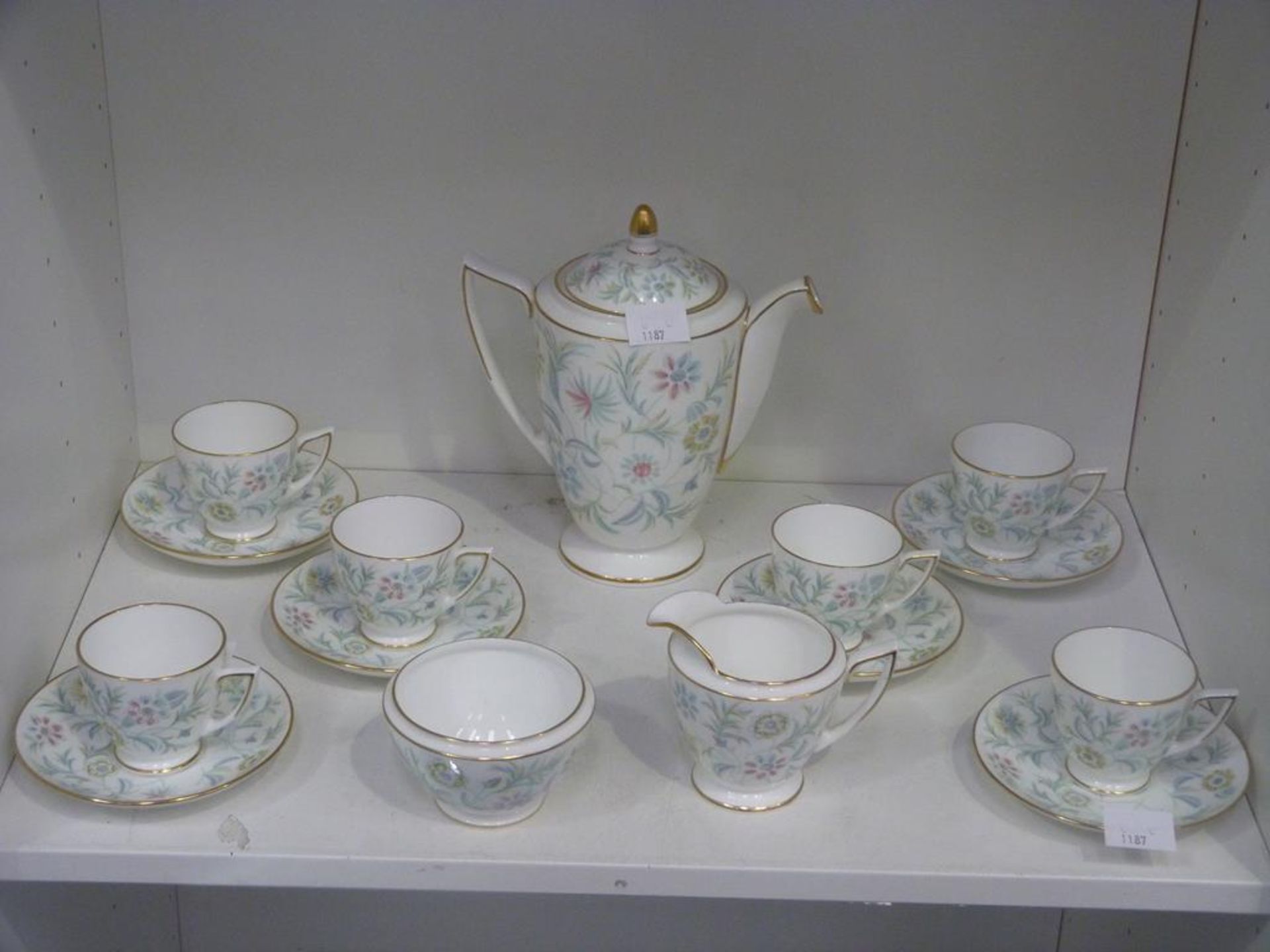 A Shelf containing a Minton Tea Service featuring a Teapot, Sugar Bowl, Milk Jug, Tea Cups and