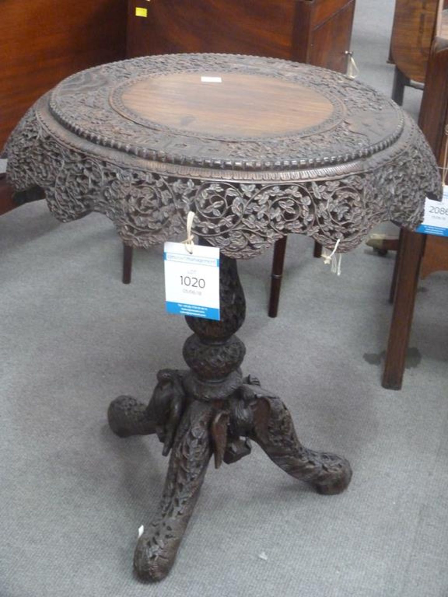 A late 19th Century Carved Burmese Rosewood Tilt-Top centre Table Ornately carved all over with