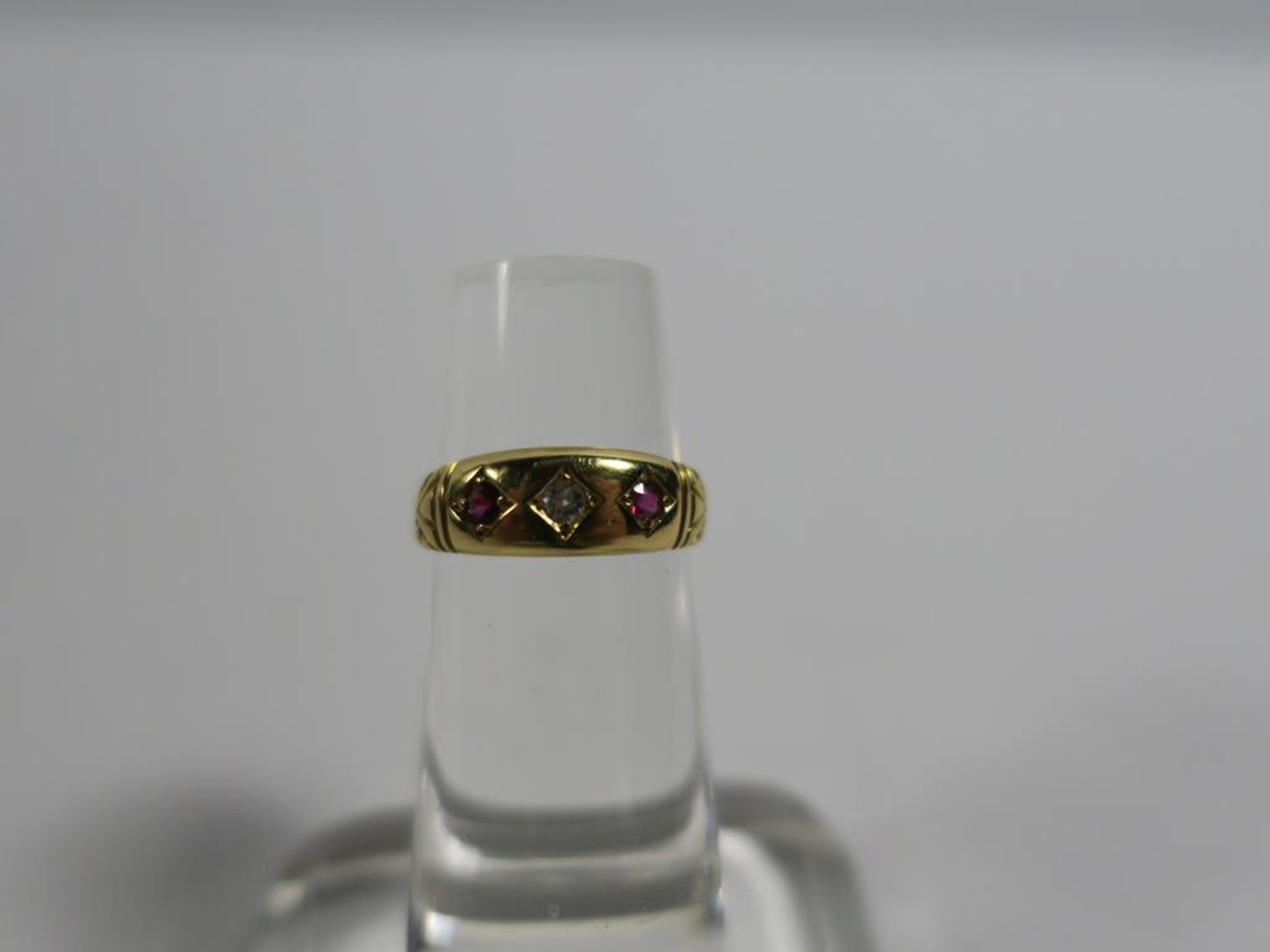 18ct Gold Ring with 1/16 Diamond and two Rubies, size K, approx 2.8g (est £120-£150)