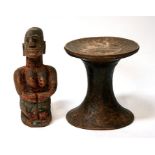 An African tribal stool of waisted from, together with a tribal figure depicting a mother and child,