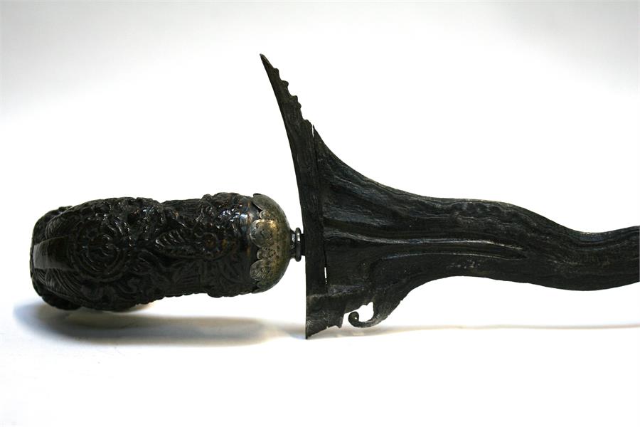 An Indonesian Kris dagger with wavy ornate blade and intricately carved handle, in silver covered - Image 8 of 12