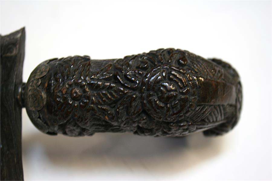 An Indonesian Kris dagger with wavy ornate blade and intricately carved handle, in silver covered - Image 12 of 12