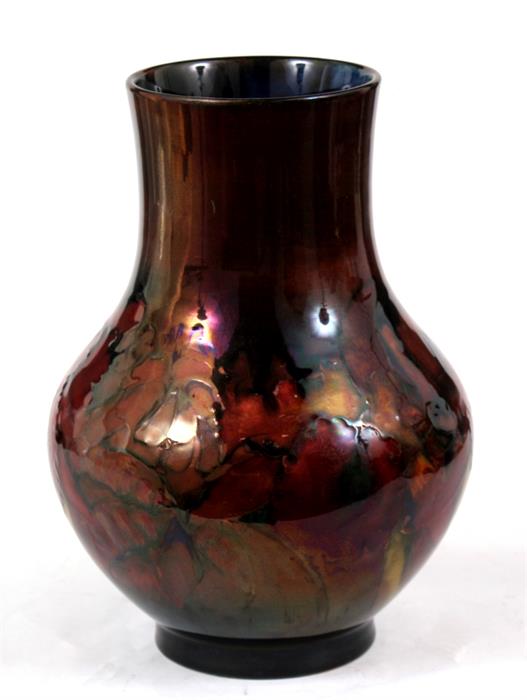 A William Moorcroft flambe vase of baluster form, decorated with flowers, with signature and