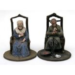 A pair of 19th century nodding figures, modelled as an old man and an old lady sat in rustic chairs,