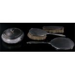 A Silver mirror and two brush set with large silver lidded and mounted powder bowl.