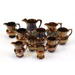 Ten assorted 19th century copper lustre jugs. Largest 19cm (7.5ins) high,