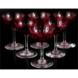 A set of six Bohemian flashed cranberry glass champagne saucers, one a/f, one with chip to foot rim.