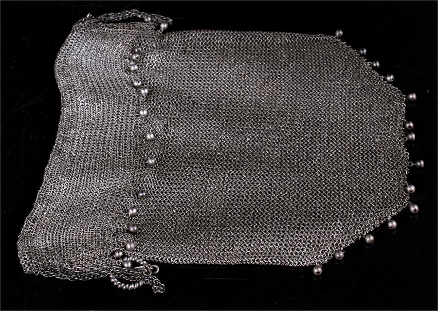 A silver (tested) early 20th century chain mesh drawstring evening bag with hanging ball decoration.