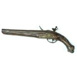 A 19th century flintlock pistol, the hardwood handle and barrel carved and with brass & white