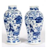 A pair of Chinese blue & white vases decorated with figures and prunus, with four character mark