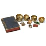 A quantity of Islamic brass bowls, a pair of folding spectacles, Hong Kong coinage, a leather ledger