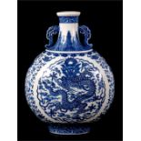 A Chinese blue & white moon flask decorated with a central dragon within foliate scrolls, with