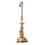 An Edwardian brass table lamp with rampant heraldic lion column, standing on three lion paw feet,