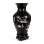 A Chinese lacquer vase, with mother of pearl decoration on black ground, 31cms (12.25ins) high.