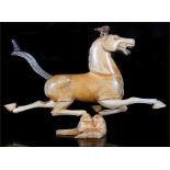 A Chinese mammoth ivory carving in the form of a horse, mounted on a bird form plinth, 22cms (8.
