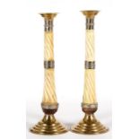 A pair of candlesticks with white metal & brass mounts, the columns of bone, 33cms (13ins) high.