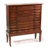 An oak collectors chest on stand, with ten long drawers, on square tapering legs, 91cms (36ins)