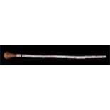 A vertebrae swagger stick with turned wooden handle 46cm (18ins) long