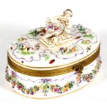 A continental porcelain oval box and cover, decorated with flower swags and insects and having a