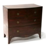 An early 19th century mahogany bowfront chest of two short and two long graduated drawers, on