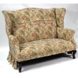 An early 20th century high backed two-seater sofa, on cabriole front supports; with similar wing