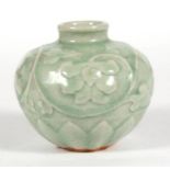A celadon glazed vase of globular form, decorated with flowers, 8cms (3.1ins) high.
