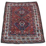 A Shiraz rug with two central guls within a foliate border, on a burnt orange ground, 164 by