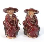 A pair of Shiwan flambe figures in the form of seated fishermen, 14cms (5.5ins) high. Condition