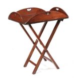 A mahogany butlers tray on folding stand, 73cms (28.75ins) wide.