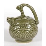 A celadon glazed teapot decorated with flowers and with a mythical beast spout, 12cms (4.75ins)