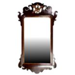 A Georgian mahogany wall mirror surmounted with an eagle, 54 by 102cms (21.25 by 40ins).