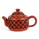 A Chinese Yixing reticulated pottery teapot, with impressed seal mark to the underside, 9cm (3.5ins)