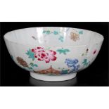 An 18th century Chinese footed bowl decorated with flowers in enamel colours, 25.5cms (10ins)