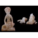 A Persian / South Arabian alabaster figure depicting a seated bearded man (fragmentary but