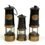 A pair of Thomas & Williams miners lamps, numbered 101 and 12, 32cms (12.5ins) high; and another