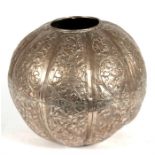 An Indian white metal vase of globular form, decorated with foliate scrolls, 15cms (6ins) high.