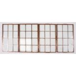 A set of four copper mounted window panes, one measures 44 by 29cms, three measure 44.1 by 26cms (