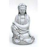 A large Chinese glazed pottery figure depicting a seated Guan Yin, 33cm (13ins) high.