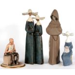 A Lladro group depicting two nuns, 33cms (13ins) high; a Lladro figure depicting a monk, 33cms (