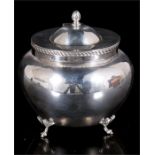 A silver tea caddy, the oval hinged lid with gadrooned edge, raised on four scroll legs, partial