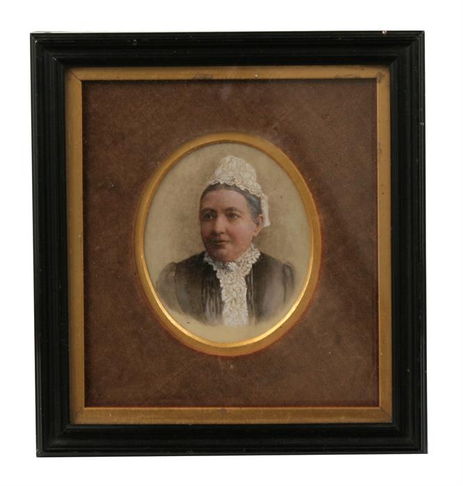 A portrait miniature of a lady in a lace bonnet and collar, in black frame, 19.5 by 18cm (7.75 by