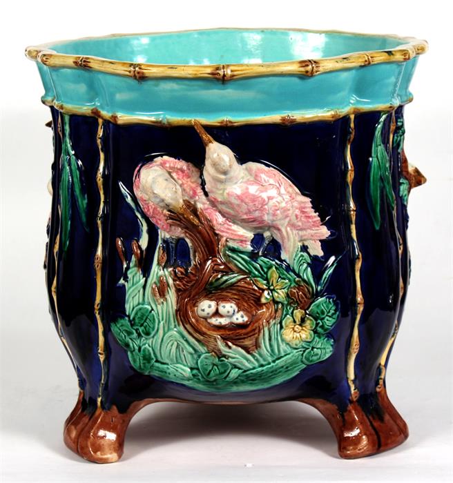 A large majolica jardiniere, decorated in relief with birds on a deep blue ground, 31cm (12.25ins)