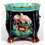 A large majolica jardiniere, decorated in relief with birds on a deep blue ground, 31cm (12.25ins)