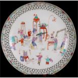 An 18th century Export Ware shallow dish, decorated with figures in enamel colours within a