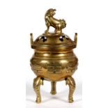 A Chinese two-handled censer with pierced cover and faux dog finial, standing on three elephant head