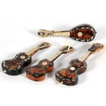 A group of tortoiseshell and mother of pearl inlaid miniature musical instruments, each approx.